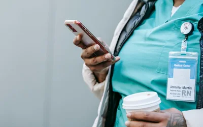 A care worker reading a message on her phone